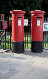 Two old traditional red pillar boxes in the street, Cambridge, England, United Kingdom, Europe