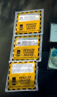Three penalty charge parking notice tickets on car windscreen