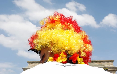 Football fan wears a wig with the colours of the German flag for the World Cup opening match