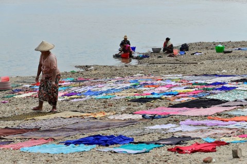 Washing clothes in the Irrawaddy, Myanmar, Asia