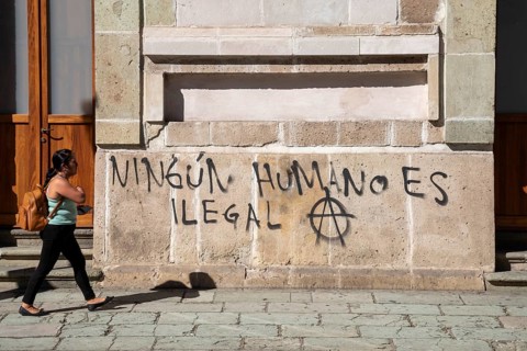 Oaxaca, Mexico, Graffiti on a wall reads No Human is Illegal. Many migrants are making their way