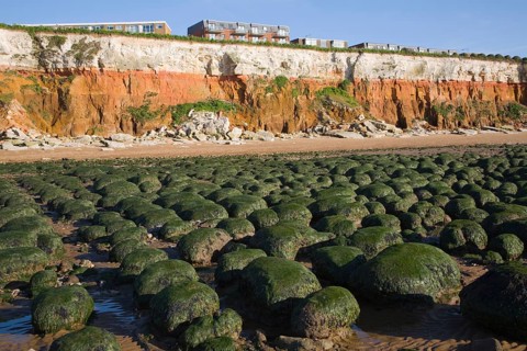 Chalk, red chalk and carstone form striped cliffs of white, red and orange at Hunstanton, Norfolk,