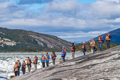 Passengers of the cruise ship Stella Australis waiting in line for a rubber dinghy at Pia Glacier,