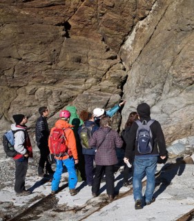 Student group of geologists on a fieldtrip at Polpeor Cove, Lizard Point, Cornwall, England, United