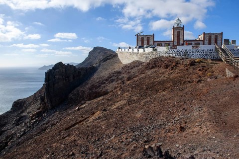 View from viewing platform on cliff of lava rock from prehistoric volcanic eruption and building