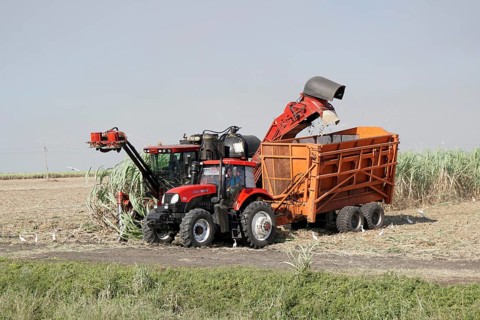 Sugar cane harvest with tractor and machine, near Santiago de Cuba, Cuba, Central America