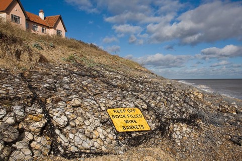 Coastal defences normally covered by shingle exposed by winter storms at Thorpeness, Suffolk,