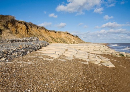 Coastal defences normally covered by shingle exposed by winter storms at Thorpeness, Suffolk,