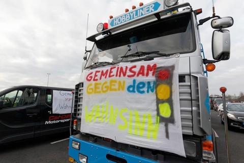 Together against the madness of traffic lights, banner on a truck, farmers' protests, demonstration