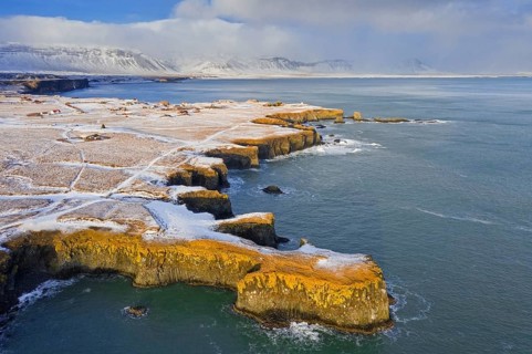 Aerial view over volcanic basalt cliff near Arnarstapi on the southern side of the Snaefellsnes