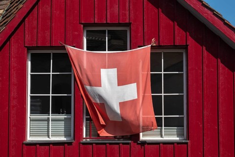 Stein am Rhein, old town, wooden house, colour red, swiss flag, wind, canton Schaffhausen,