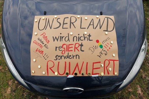 Sign criticising the government on a car, farmers' protests, demonstration against policies of the