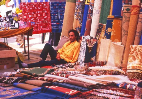 Resting carpet seller at market in Torre del Mar, Andalusia, Spain, Southern Europe. Scanned