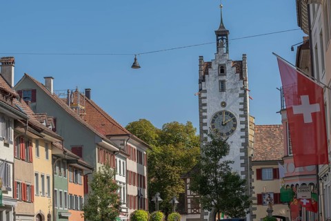 Old town of Dissenhofen on the Rhine, town gate, tower clock with zodiac sign, Swiss flag,