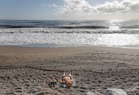 A man sunbathes on the deserted beach of Torremolinos, Spain, Costa del Sol, 13/02/2019, Europe
