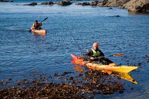 Two men fishing from kayak canoes off Lizard Point, Cornwall, England, United Kingdom, Europe