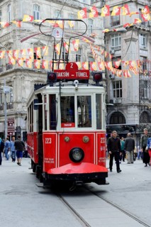 Historic tram Nostaljik Tramvay travelling through Istiklal Caddesi shopping street, Beyoglu,