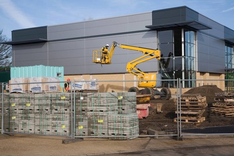 Cherry picker crane at construction site, UK