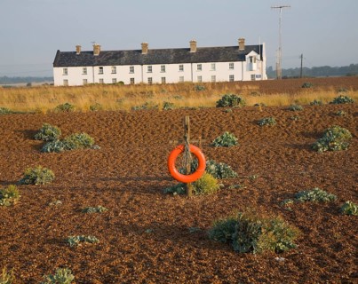 Row of white houses, Coastguard Cottages, at Shingle Street, Suffolk, England, United Kingdom,
