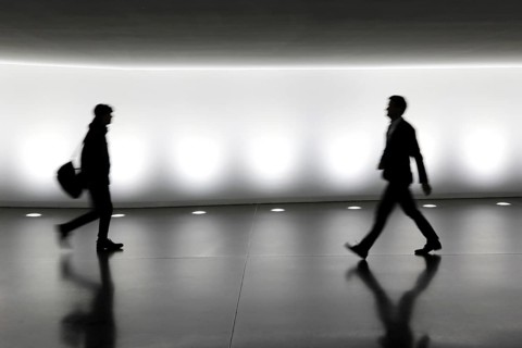 Members of the German Bundestag walk through a tunnel. The tunnel connects the Reichstag and the