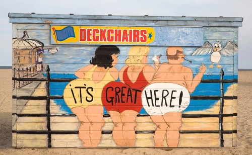 Painted deckchair hire shed with traditional seaside picture of people in swimming costumes, Great