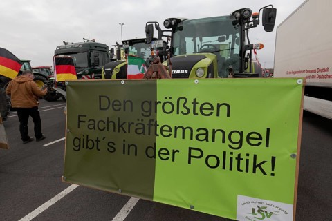 Sign on the subject of shortage of skilled labour on a tractor, farmers' protests, demonstration