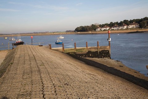 Concrete inclined sea wall embankment River Deben, Felixstowe Ferry, Suffolk, England, United