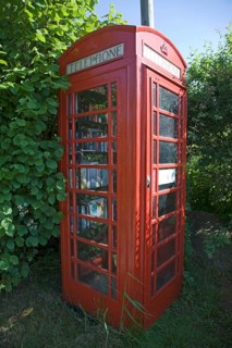 Old red telephone box used for book exchange, Suffolk, England, United Kingdom, Europe