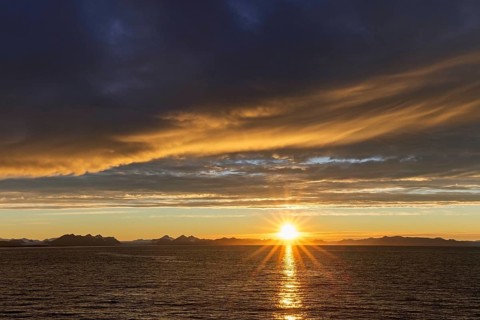 Sun setting on a rainy evening over Isfjorden, Isfjord in summer at sunset, Spitsbergen, Svalbard,