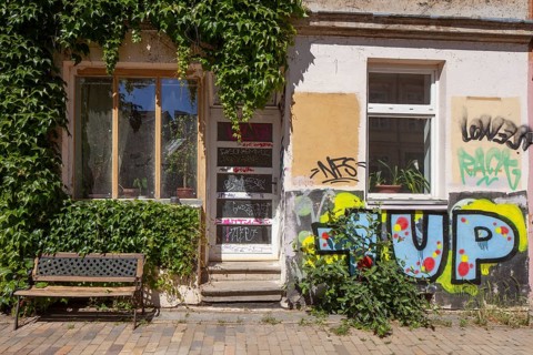 Colourfully smeared old house entrance in the Kroepeliner-Tor-Vorstadt, Rostock,