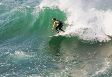 Young man wearing wet-suit surfing in Cornwall, England, United Kingdom, Europe