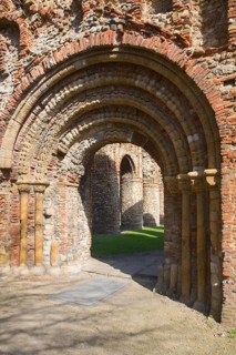 Elaborate Norman doorway of the west front of Saint Botolph's priory, Colchester, Essex, England,