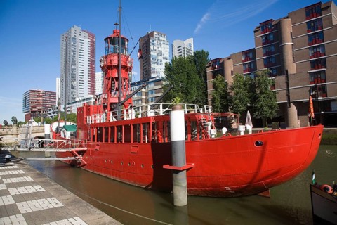 Historic red lightship floating restaurant and modern architecture Wijnhaven, Rotterdam,