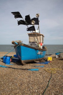 Fishing boats and equipment on the shingle beach at Aldeburgh, Suffolk, England, United Kingdom,