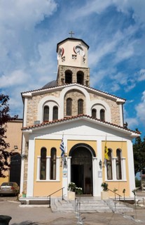 Facade of an orthodox church with a bell tower and Greek flag, Holy Church of the Assumption, Old