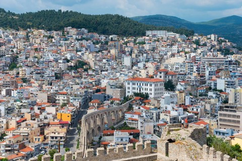 Roman aqueduct, dense development of a town situated on the slopes of a hill, view from the