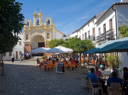People gather in cafes and by the baroque church of San Juan at Zahara de la Sierra, Spain Sunday