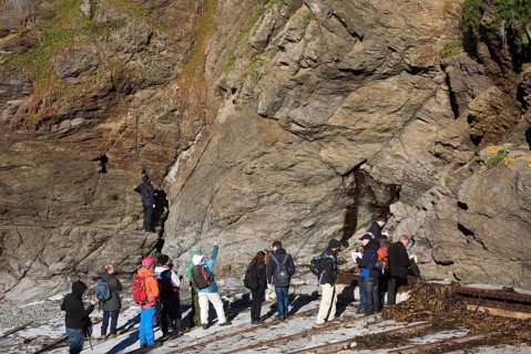 Student group of geologists on a fieldtrip at Polpeor Cove, Lizard Point, Cornwall, England, United