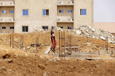 Young men working on a construction site in Nigeria, 06.02.2024