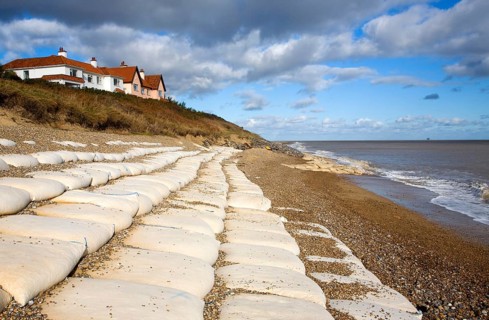 Coastal defences normally covered by shingle exposed by winter storms at Thorpeness, Suffolk,