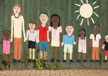 Painted collage picture of young children on a nursery school fence, Wickham Market, Suffolk,