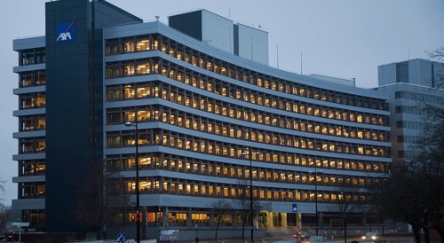 AXA insurance office illuminated by electric lights in winter afternoon, Ipswich, Suffolk, England,