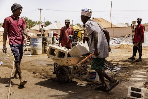 Young men working on a construction site in Nigeria, 06.02.2024