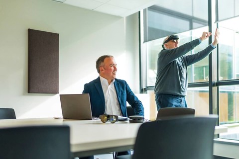 Businessmen wearing smart virtual glasses and joining business meeting on augmented reality