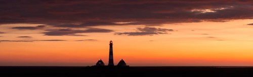 Lighthouse Westerheversand at sunset in summer, Westerhever, Wadden Sea National Park, North