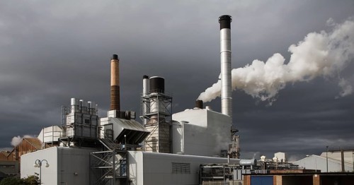 Steam rising from chimneys as sugar beet is processed at the British Sugar factory, Bury St