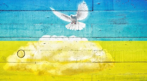 Dove of peace on a concrete wall in the colours of the Ukrainian flag