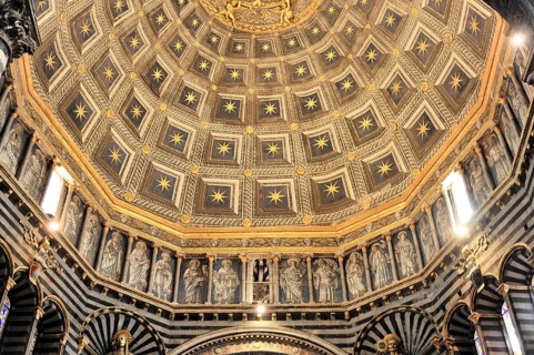 The dome of the cathedral with starry sky and black and white striped marble columns and round