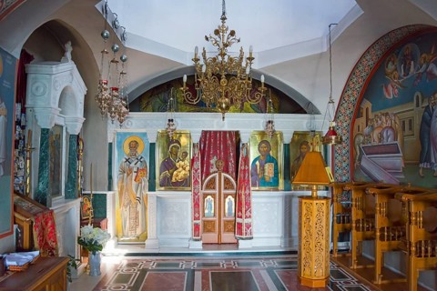 Interior view of a small church with richly decorated iconostasis and frescoes, Monastery of St