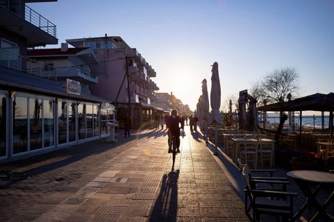Cyclists and walkers, beach promenade, beach cafe, waterfront promenade, sunset, evening light,